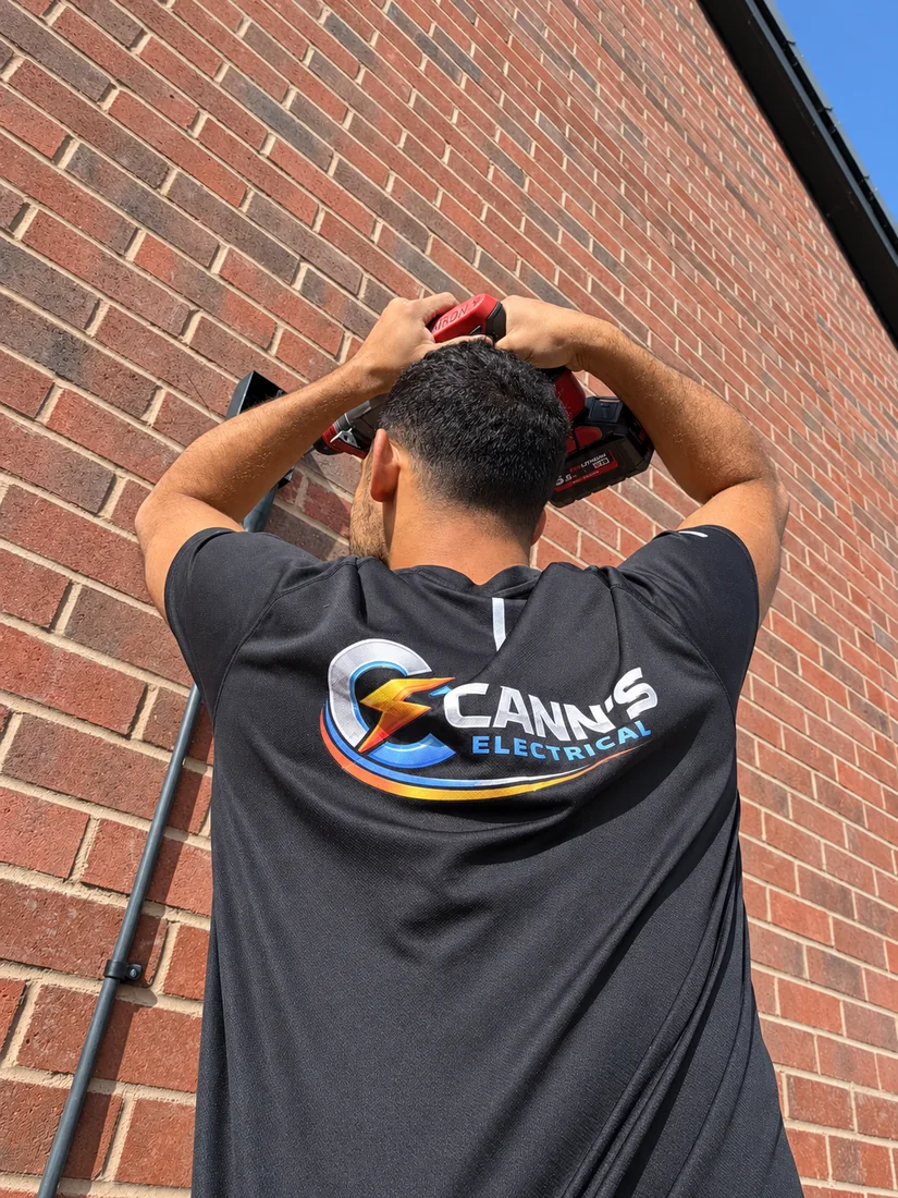 Cann's Electrical fitting a light to a house wall in Cardiff